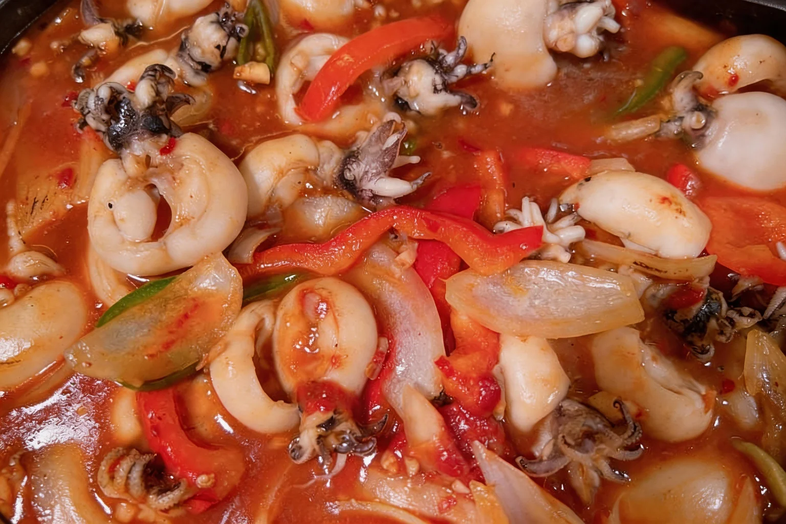 Seafood in spicy sauce, close-up.